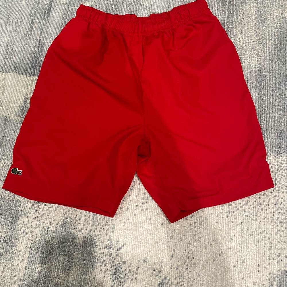 Boys Lacoste shorts.
